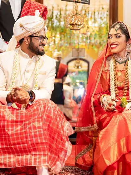 A couple shares a smile during their royal wedding ceremony at the magnificent Lalitha Mahal Palace in Mysore. I have experience planning weddings in grand, heritage venues.