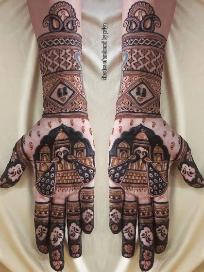 Symmetrical bridal mehendi for both hands, featuring majestic peacocks against an architectural backdrop. This design uses bold lines and filled spaces for a dramatic effect.