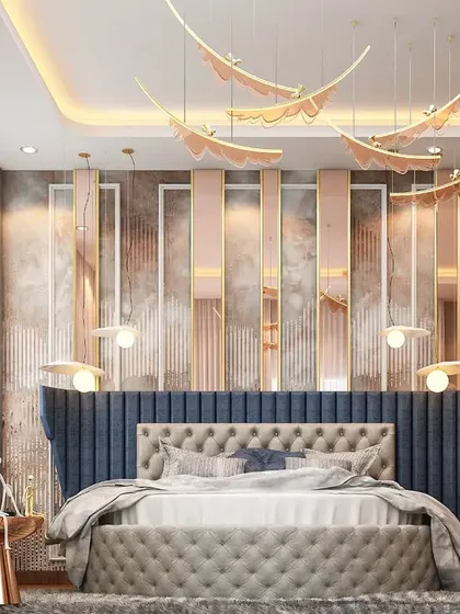 We designed this bedroom with a unique, tufted headboard that extends up the wall in a striking blue fabric. The design incorporates soft pink and metallic panels, creating a layered and visually interesting backdrop.