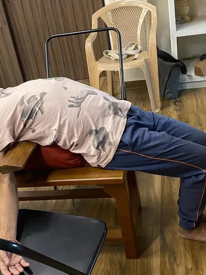 A student in a supported chest-opening pose on a yoga bench. This allows the heart to breathe and is deeply calming for the entire nervous system.