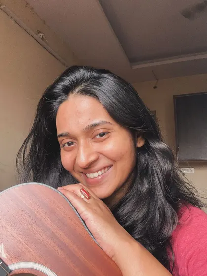 A direct-to-camera smile with my guitar. This instrument is like an extension of me.