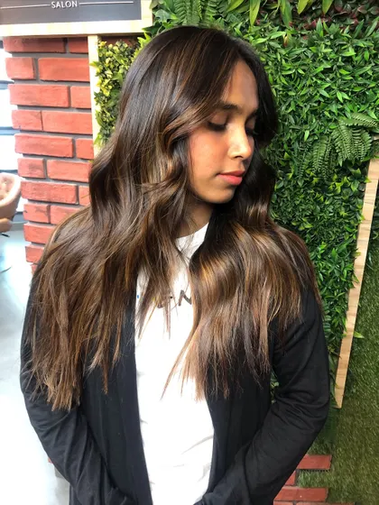 The client showcasing her new caramelized balayage. The money piece frames her face beautifully, and the tones are perfect for her skin.