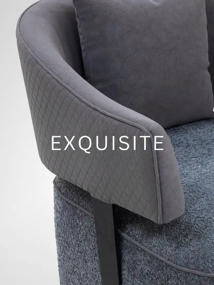 Sculpted for comfort and designed for movement. This grey swivel armchair features a unique, deconstructed design with a quilted backrest and a sturdy metal base.