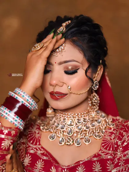 A close-up of another beautiful bride, showcasing her bold red lip and smoky eye. Her dark green nails provide a chic, contemporary edge to the traditional bridal aesthetic.