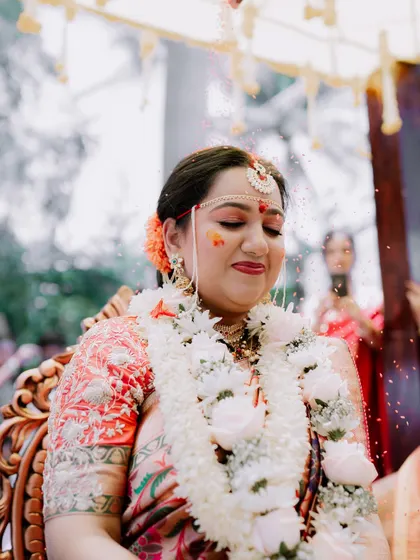 A serene moment as the bride is showered with rice and petals during her wedding ceremony.