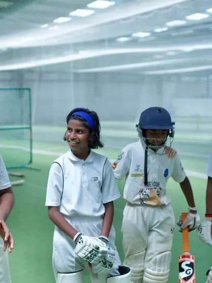 A coach shares a light-hearted moment with young players. Building a strong, positive relationship between mentor and student is key to our philosophy.