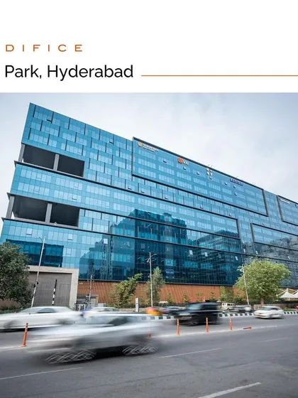The V Park in Hyderabad, a dynamic IT campus designed to serve as a vibrant public realm. The building's angled glass facade reflects the energy of HITEC City, while the ground level is activated with retail and public spaces.