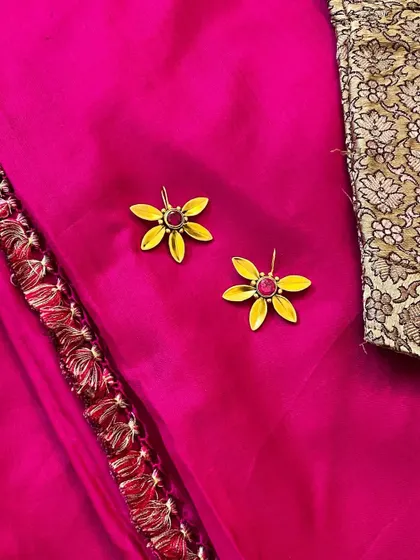 These flower-shaped earrings with a pink stone center are one of my most loved designs from the festive season. They are light, bright, and add a touch of fun.
