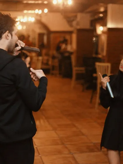 Me joining in for a duet. I often jump on stage to sing with guests and keep the energy flowing.