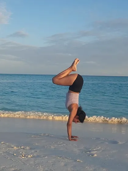 Happiness is finding a moment of balance by the sea. A simple tuck handstand on the sand, connecting with the elements and my own inner strength.