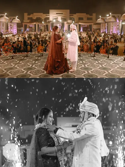The Varmala ceremony at a grand indoor wedding, captured in both color and dramatic black and white with sparklers.