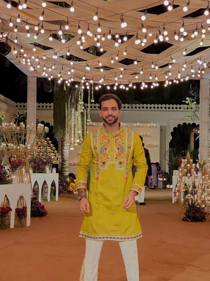 A full frontal view of my embroidered green kurta. I pay attention to detail in my outfits, just as I do in my hosting.