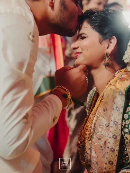 A tender moment where the groom blesses his bride, a close-up filled with emotion and tradition.