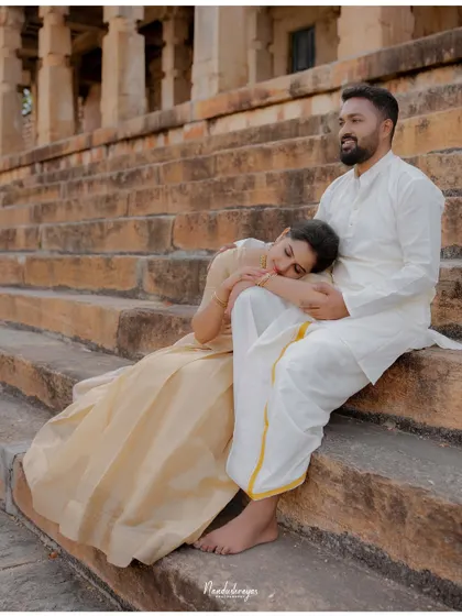 A peaceful moment with the bride-to-be resting her head on her partner's lap on the temple steps.