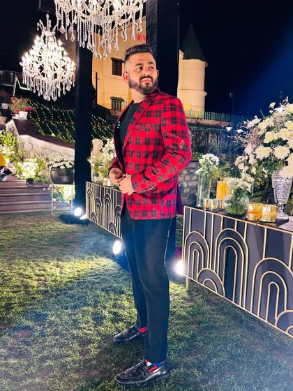 Suited up for a glamorous outdoor wedding reception. The stunning chandeliers and elegant decor call for a sophisticated and high-energy playlist.
