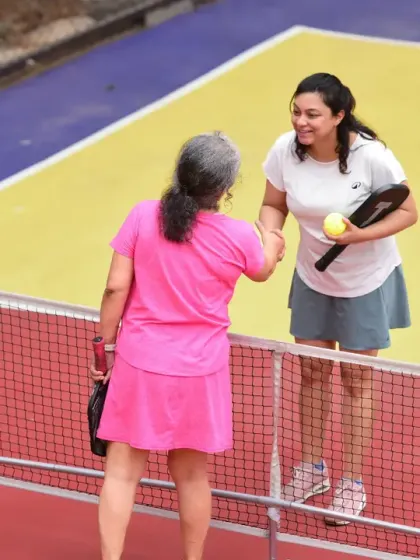 A handshake across the net shows the respect and camaraderie within our pickleball community, even in the heat of competition.