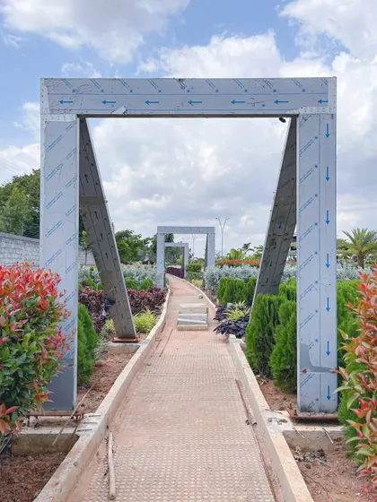 A modern archway at 'The Sanctuary' frames the pathway, creating a sense of entry and rhythm along the walking route.