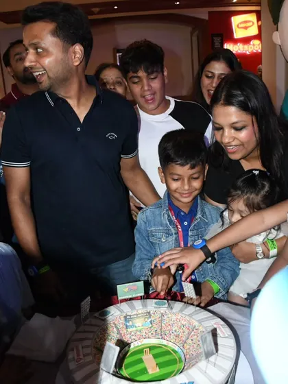 The excitement is palpable as the family celebrates Prishiv's 8th birthday with his custom cricket stadium cake.