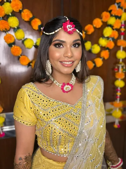 A bright and happy mehendi look for Simran. The makeup is fresh and dewy, with a focus on natural, glowing skin.
