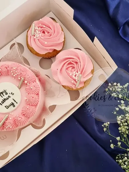 A Mother's Day gift set with a mini cake and matching cupcakes. The simple pink rose piping is so classic and pretty.