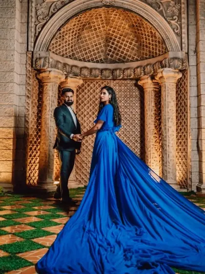 The long trail of our royal blue gown sweeps across the frame in this elegant evening photoshoot.