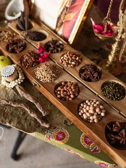 A close-up of the Navadhanyam (nine grains) and heirloom sarees at the legacy counter, a tribute to family heritage.