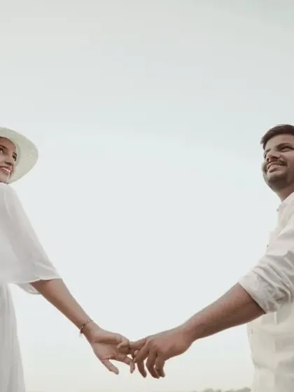 A beautiful 'follow me' style shot on the beach. Her happy glance back invites you into their love story.
