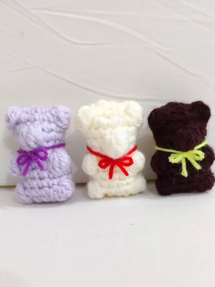 A trio of colorful gummy bear keychains.