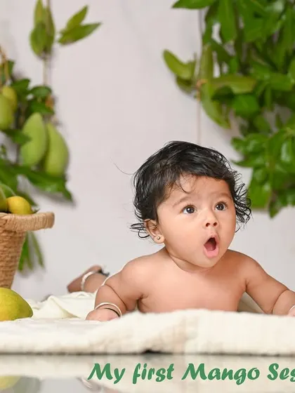 A seasonal 'Mango Session' for a 5-month-old. The baby's surprised expression is priceless! I love incorporating natural elements into my shoots.