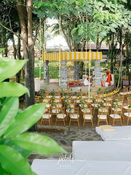 This overhead view showcases the complete traditional wedding setup at Angana the Courtyard. The floral arrangements, ceiling decor, and elegant Tiffany chairs come together to create an enchanting and cohesive atmosphere.
