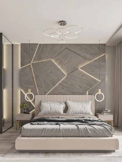 A full view of a modern bedroom with a geometric, backlit accent wall, showcasing the room's balanced layout and contemporary lighting fixtures.
