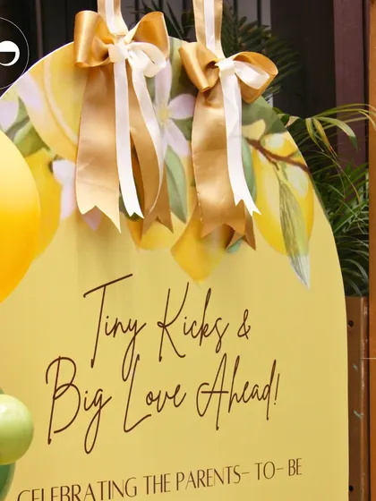 A close-up of the welcome sign for a citrus-themed baby shower. The sign, adorned with lemon illustrations and elegant ribbons, set a sunny and cheerful tone right from the entrance.
