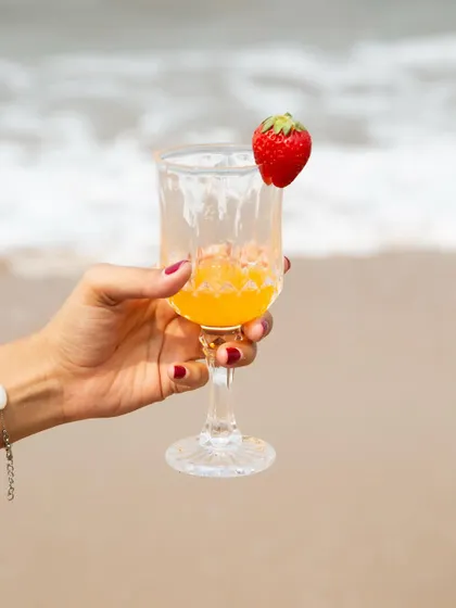 A product-focused shot of a summer drink on the beach, showing I can also create content that highlights a specific item.