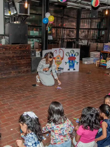 An instructor demonstrates how to use the monster-themed game. We guide the children through each activity, ensuring they understand the goal and have fun while learning.