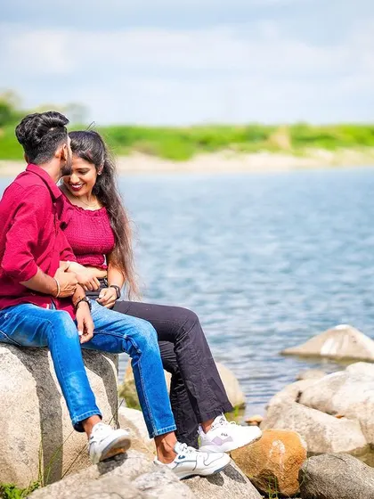 A sweet, intimate moment between the couple as they sit on a rock by the lake, lost in their own world.