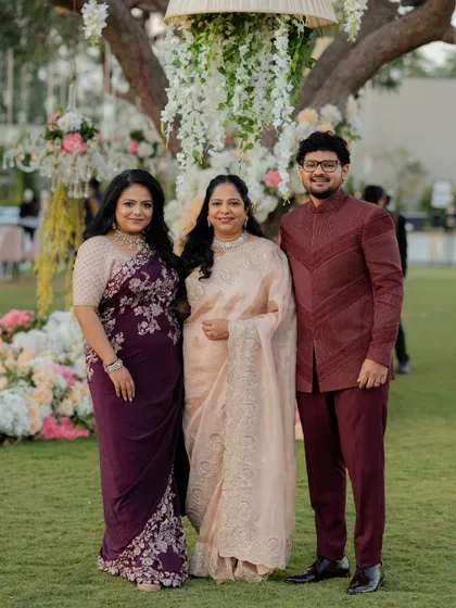 The bride, groom, and mother of the groom in a coordinated family look, demonstrating how we create a unified visual story.
