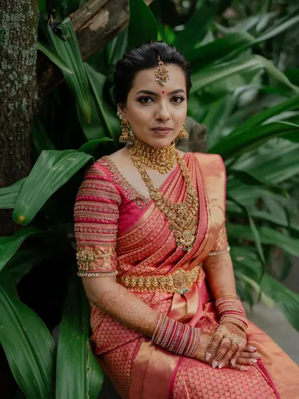 A classic bridal portrait showcasing the intricate details of the saree, jewelry, and makeup. We ensure every element of the bride's look is captured perfectly.