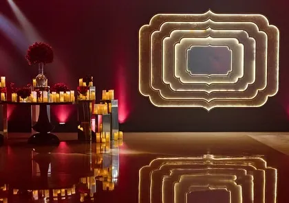A photo booth area at the 'Raga Saga' event, featuring a custom-lit frame for guests to capture memories.