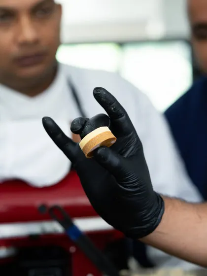 A close-up of a perfectly layered tart ring, demonstrated during the Pastry Symposium with Marriott. It's all about precision and technique.