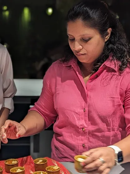 For me, my most prized inheritance was the food. Here I am plating up small portions for an event, making sure every single serving is perfect. It's a joy to share these recipes that generations of my family have perfected.