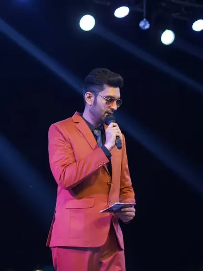 Reviewing my notes on stage. Preparation meets performance under the spotlight.