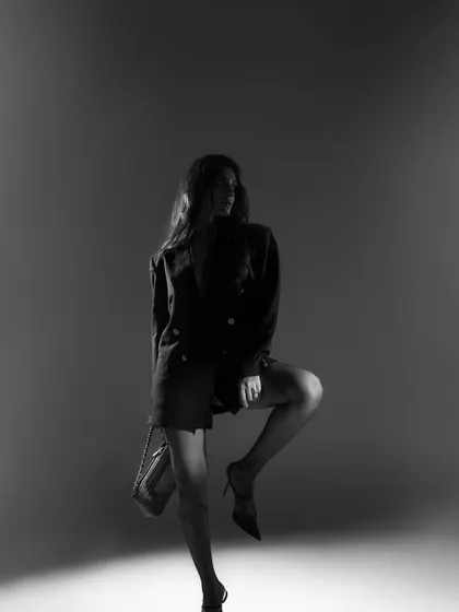 A dramatic full-length silhouette in black and white. This artistic shot focuses on form and mood, creating a powerful fashion statement.
