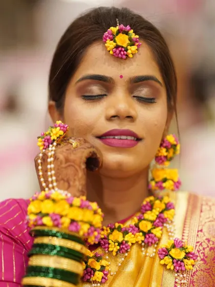 A serene close-up of the Haldi bride, showcasing the soft brown eyeshadow and flawless skin.