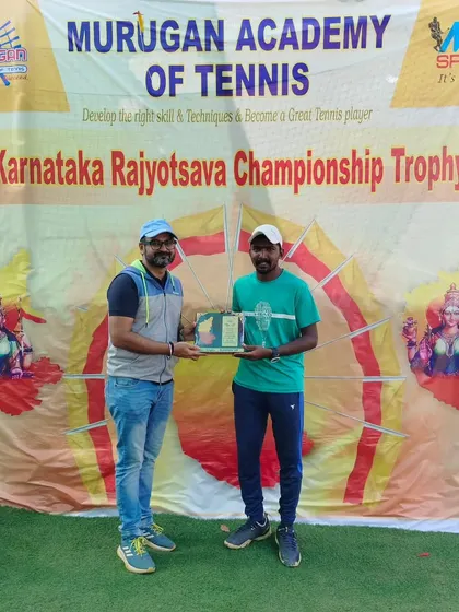Presenting the Men's Singles Finalist trophy to Raju Muthu at the Karnataka Rajyotsava Championship. Even our coaches compete, setting a great example for our students.
