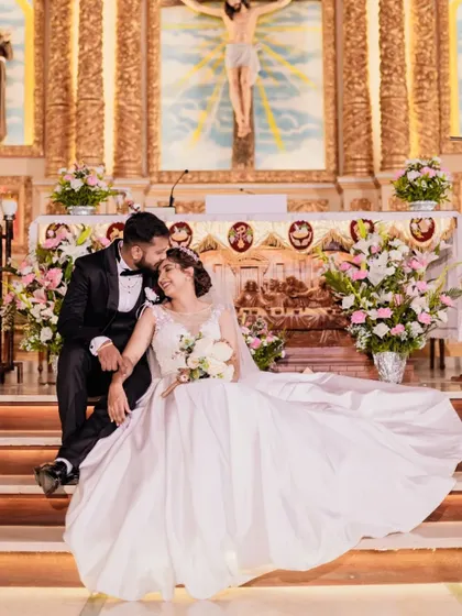 A fairytale moment on the church steps. This bride's ball gown and her husband's loving gaze create a picture-perfect scene.