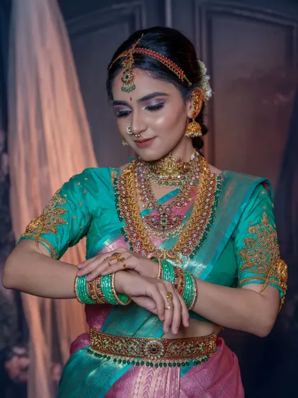 A final check before the big moment. The makeup is perfect, the jewellery is in place, and the bride looks absolutely stunning.