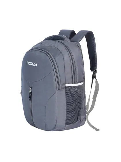 An angled shot of a grey American Tourister backpack, giving a dynamic view of the product.