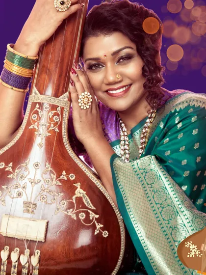 A beautiful portrait of me with a sitar, representing my deep connection and expertise in Indian classical music, which I share with all my students.