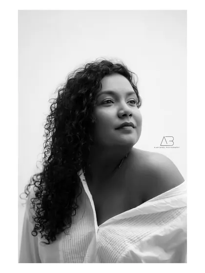 There's a truth that black and white photography reveals. By stripping away color, we get to the core of the person. This portrait is all about her expression and the quiet confidence she exudes.