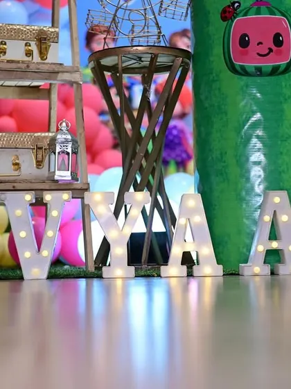A close-up of the light-up LED letters used in a Cocomelon themed party. This is a great way to personalize the decor and make the birthday child feel special.